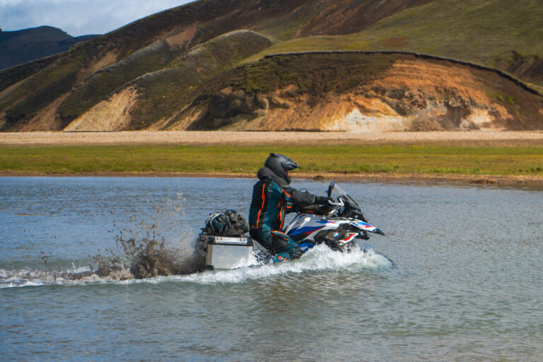motorcycle crossing a river in landmannalaugar